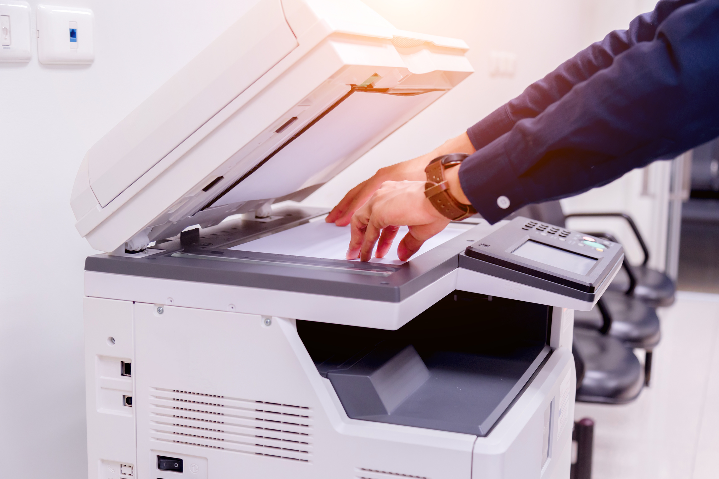 Close-up business man Hand press button on panel of printer, printer scanner laser office copy machine supplies start concept.